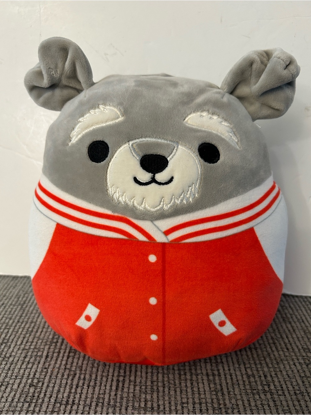 Squishmallows Shaun the Schnauzer Dog featuring a red varsity jacket 8”